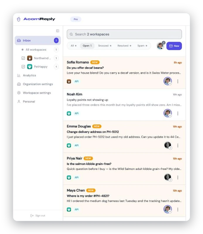 The AcornReply sidebar with the workspace switcher — All workspaces, Northwind Coffee, and PetHappy — above a unified inbox listing conversations from both workspaces.